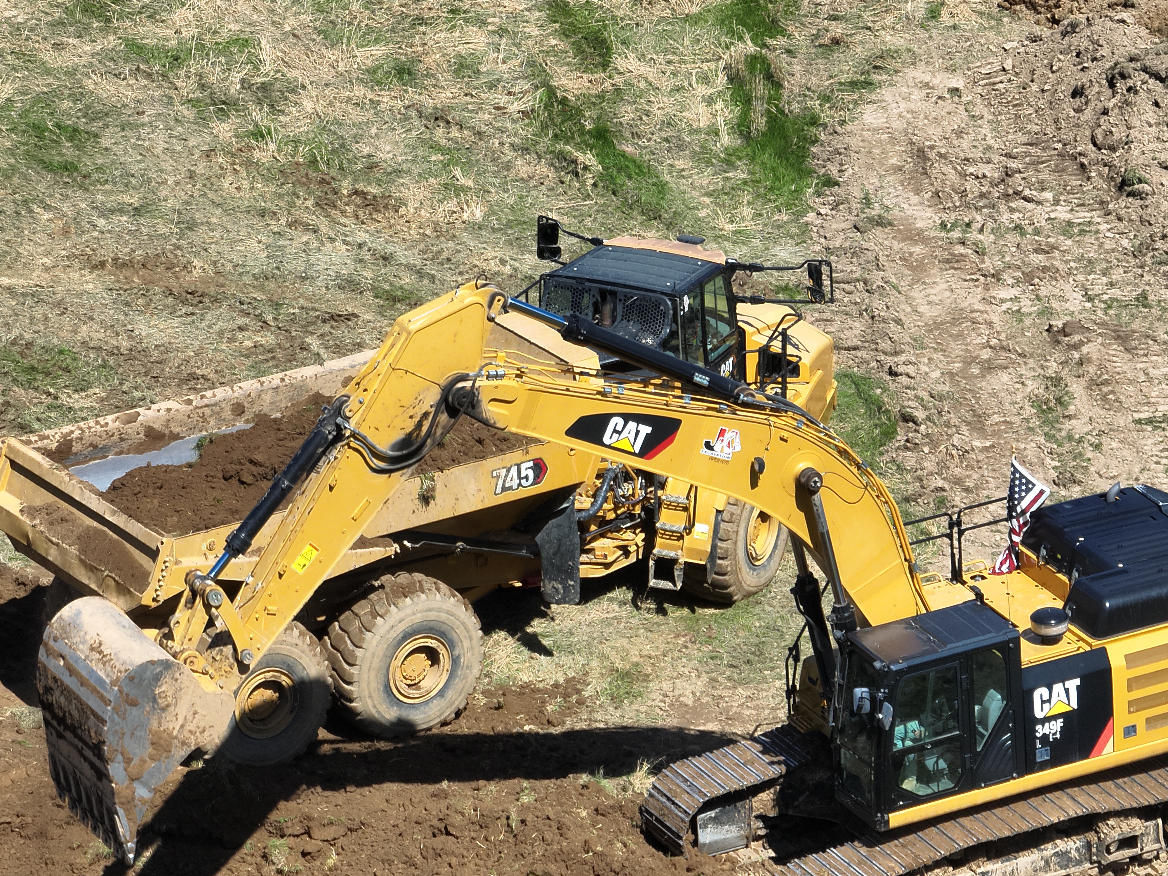 JKE (Josh King Excavation) excavator loading into dump truck